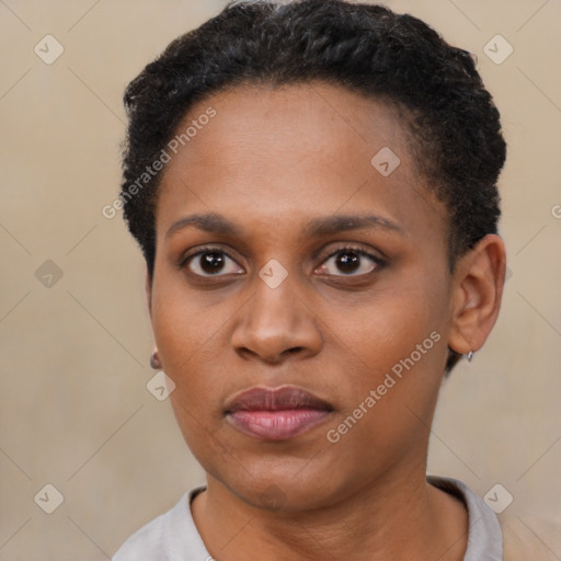 Joyful black young-adult female with short  black hair and brown eyes