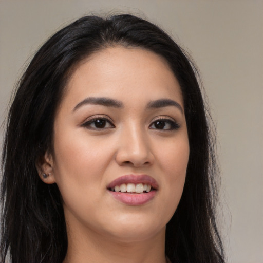 Joyful latino young-adult female with long  brown hair and brown eyes