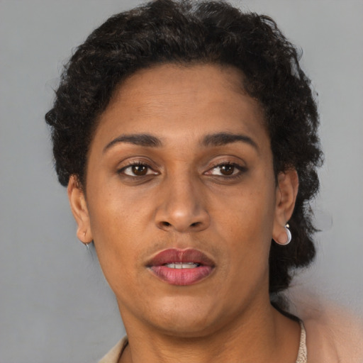 Joyful black adult female with short  brown hair and brown eyes