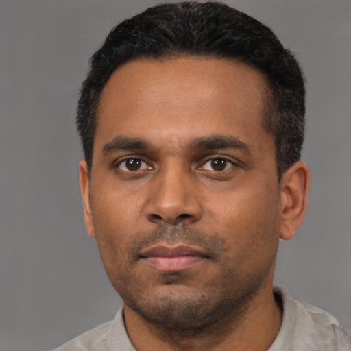Neutral black young-adult male with short  black hair and brown eyes