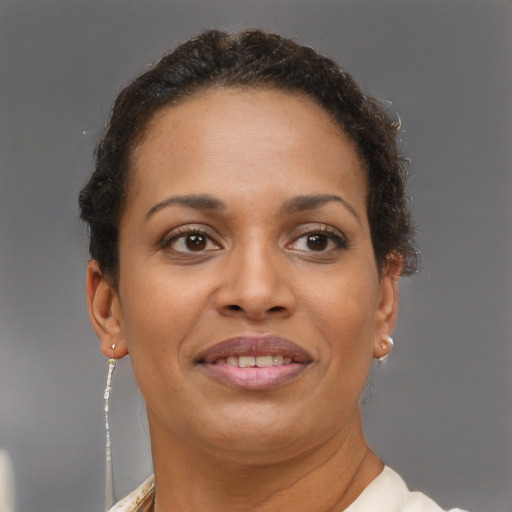 Joyful black adult female with short  brown hair and brown eyes