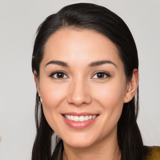 Joyful white young-adult female with long  black hair and brown eyes