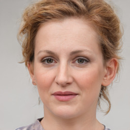 Joyful white young-adult female with medium  brown hair and blue eyes