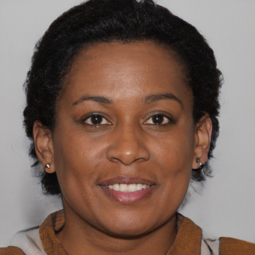 Joyful black young-adult female with medium  brown hair and brown eyes