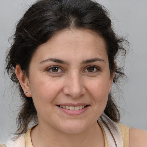 Joyful white adult female with medium  brown hair and brown eyes