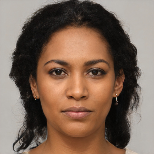 Joyful black young-adult female with medium  black hair and brown eyes