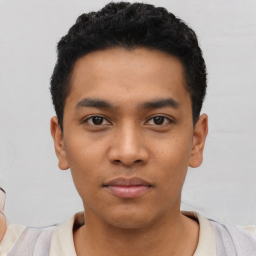Neutral latino young-adult male with short  black hair and brown eyes