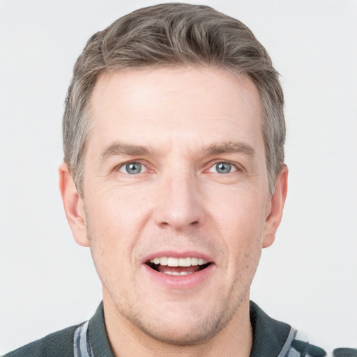 Joyful white adult male with short  brown hair and grey eyes