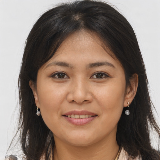 Joyful asian young-adult female with long  brown hair and brown eyes