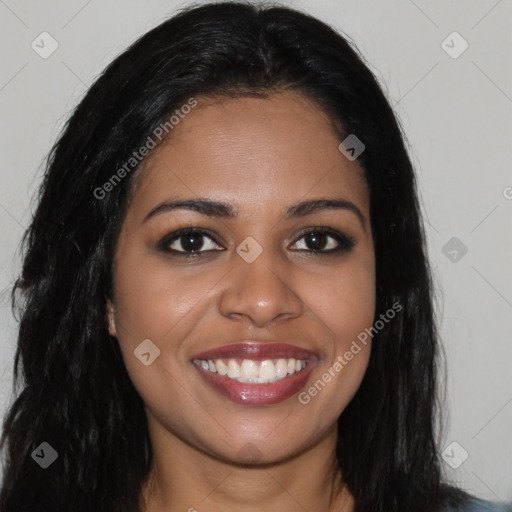 Joyful black young-adult female with long  brown hair and brown eyes