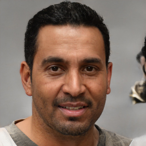 Joyful white adult male with short  black hair and brown eyes