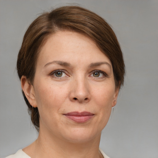 Joyful white adult female with medium  brown hair and grey eyes