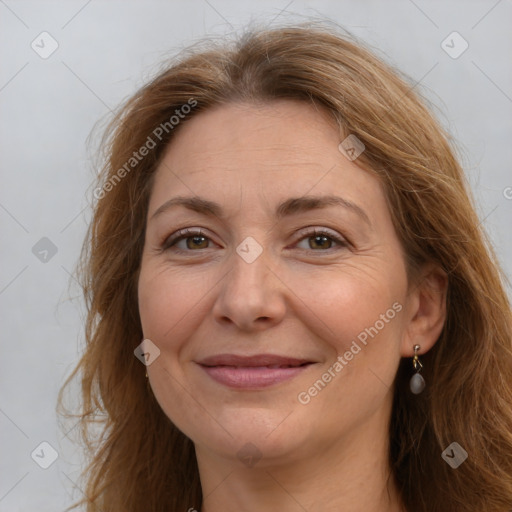 Joyful white adult female with long  brown hair and brown eyes