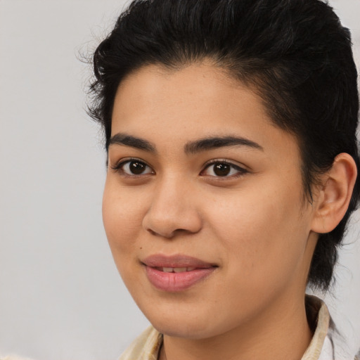 Joyful latino young-adult female with medium  brown hair and brown eyes