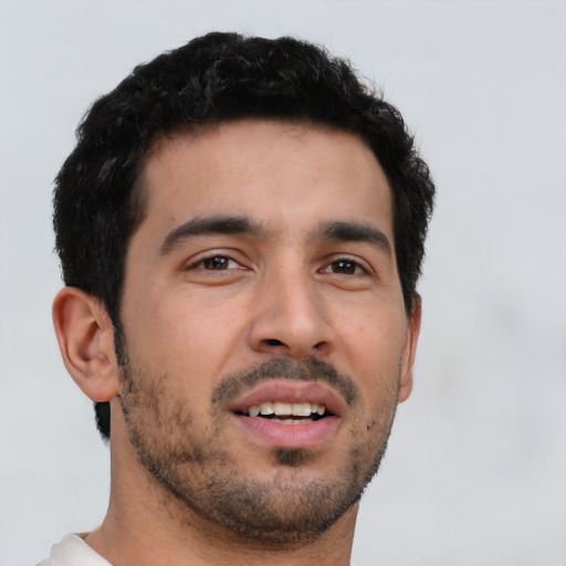 Joyful latino young-adult male with short  brown hair and brown eyes