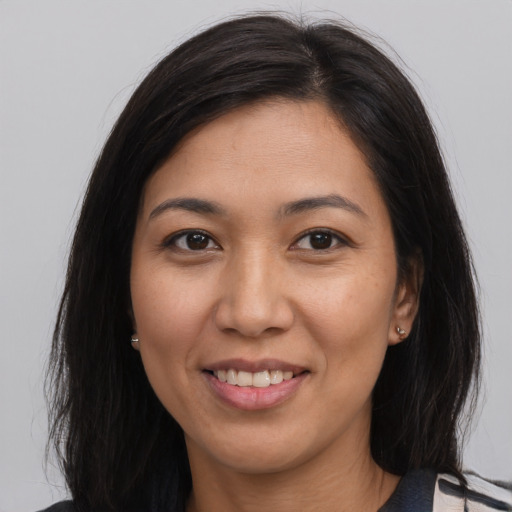 Joyful asian adult female with medium  brown hair and brown eyes