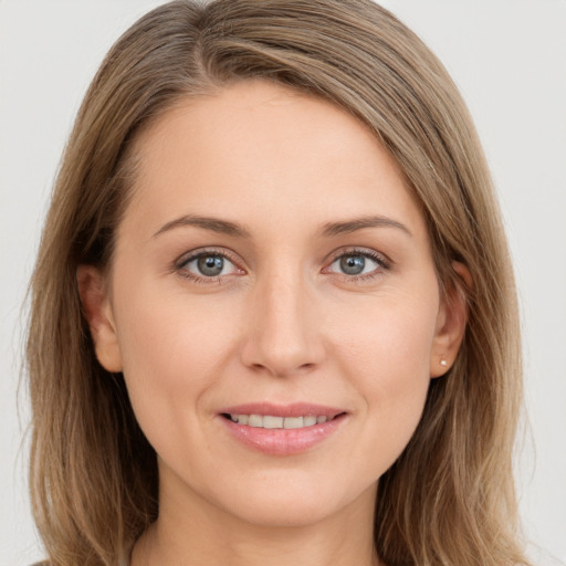 Joyful white young-adult female with long  brown hair and grey eyes