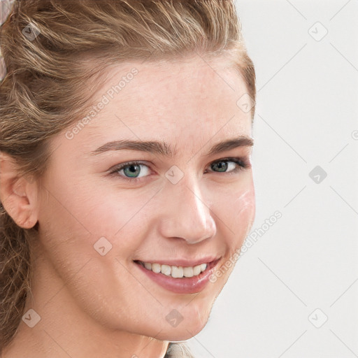 Joyful white young-adult female with long  brown hair and blue eyes