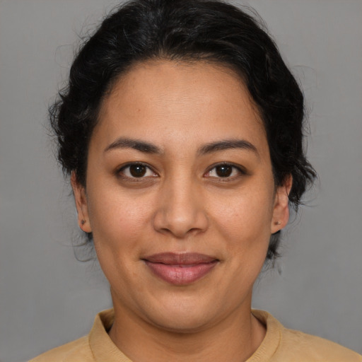Joyful latino adult female with short  brown hair and brown eyes