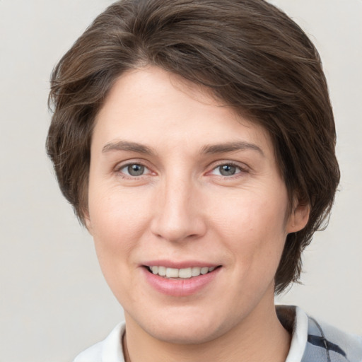 Joyful white young-adult female with medium  brown hair and grey eyes