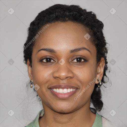 Joyful black young-adult female with long  black hair and brown eyes