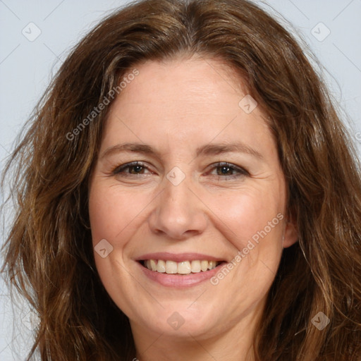 Joyful white adult female with long  brown hair and brown eyes