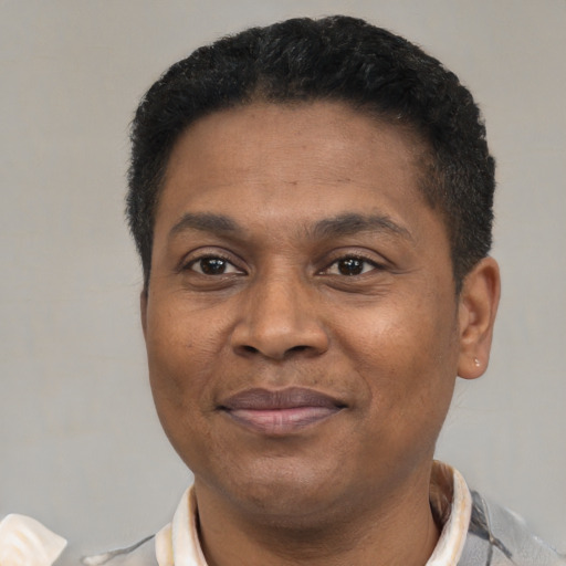 Joyful latino adult male with short  black hair and brown eyes