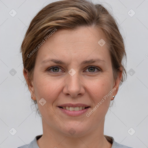 Joyful white adult female with medium  brown hair and grey eyes