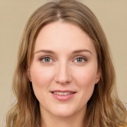 Joyful white young-adult female with long  brown hair and green eyes