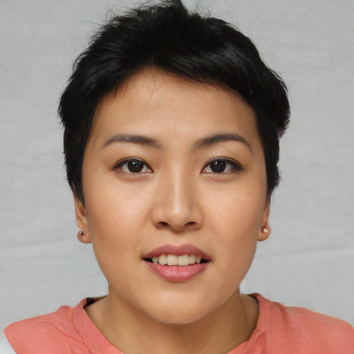 Joyful asian young-adult female with short  brown hair and brown eyes
