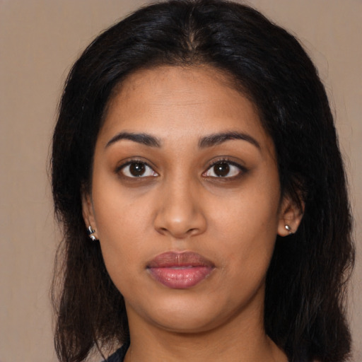 Neutral latino young-adult female with long  brown hair and brown eyes