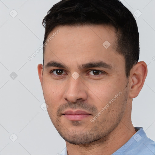 Joyful white young-adult male with short  black hair and brown eyes