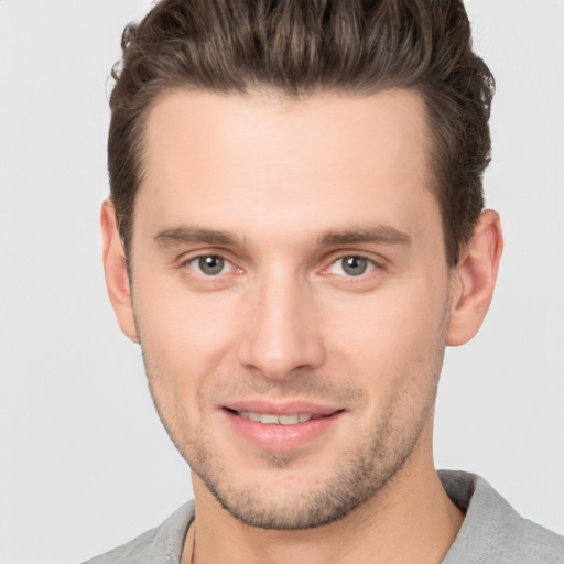 Joyful white young-adult male with short  brown hair and brown eyes