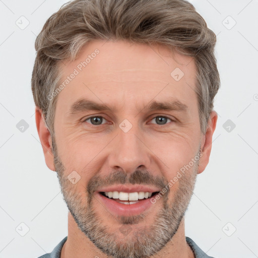 Joyful white adult male with short  brown hair and grey eyes