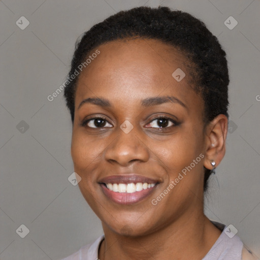 Joyful black young-adult female with short  black hair and brown eyes