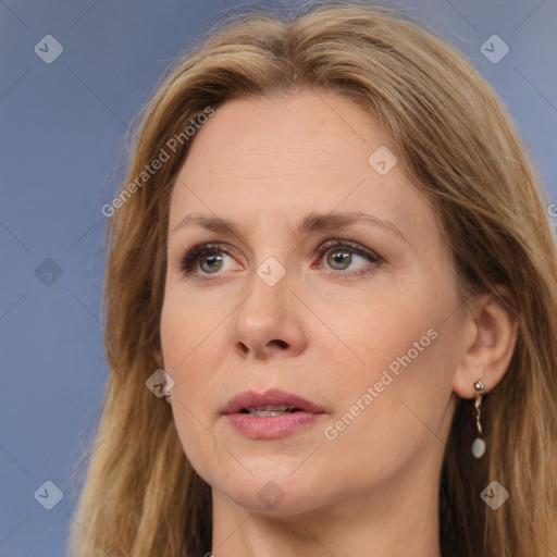 Joyful white adult female with long  brown hair and brown eyes