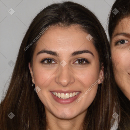 Joyful white young-adult female with long  brown hair and brown eyes