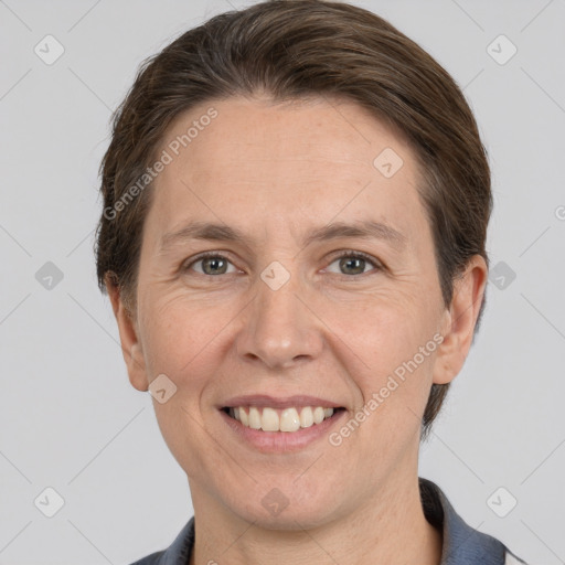 Joyful white adult female with short  brown hair and grey eyes