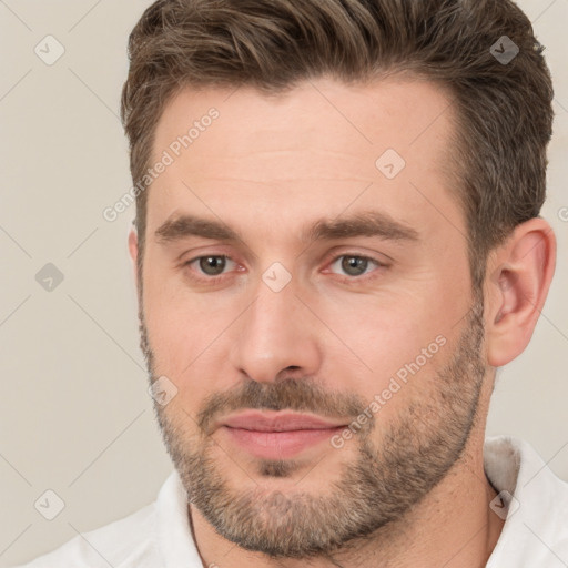 Joyful white young-adult male with short  brown hair and brown eyes