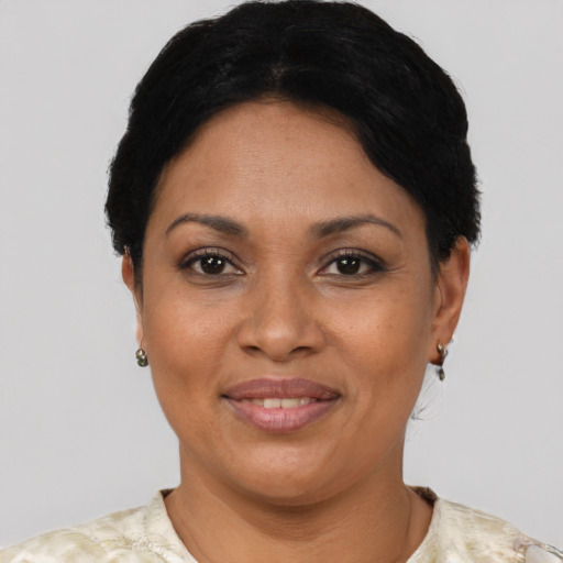 Joyful latino adult female with short  black hair and brown eyes
