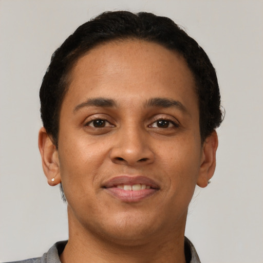 Joyful latino young-adult male with short  brown hair and brown eyes