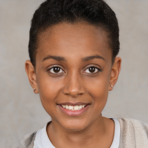 Joyful black young-adult female with short  brown hair and brown eyes