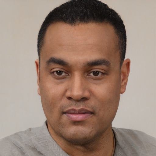 Neutral latino young-adult male with short  black hair and brown eyes