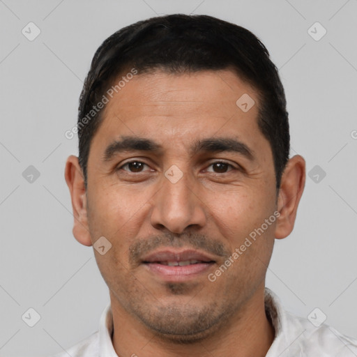 Joyful white adult male with short  black hair and brown eyes
