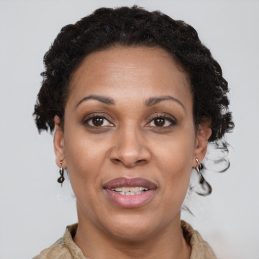 Joyful black adult female with short  brown hair and brown eyes