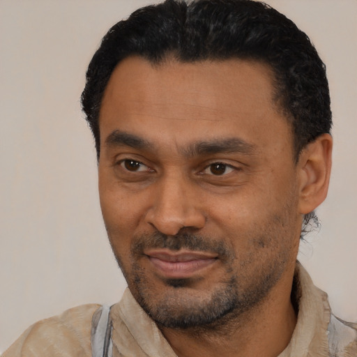 Joyful latino adult male with short  black hair and brown eyes