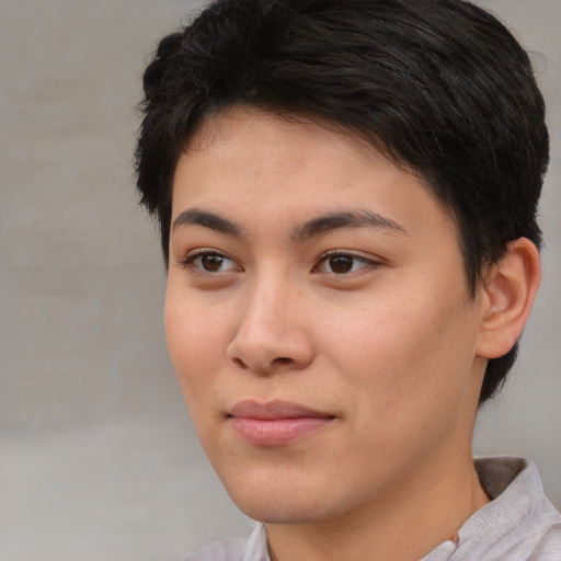 Joyful asian young-adult female with short  brown hair and brown eyes