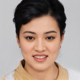 Joyful asian young-adult female with medium  black hair and brown eyes