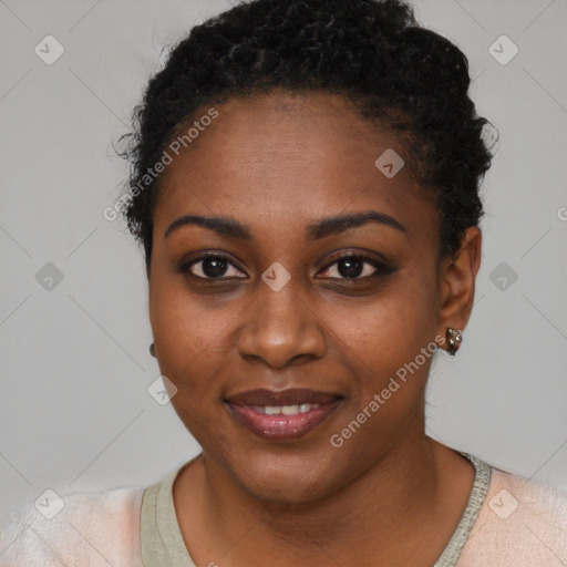 Joyful black young-adult female with short  black hair and brown eyes