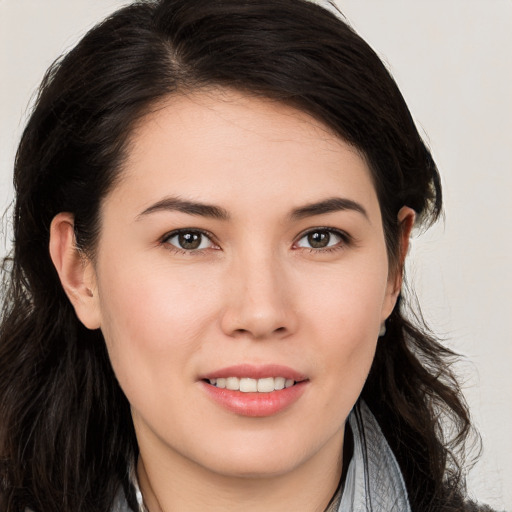 Joyful white young-adult female with long  brown hair and brown eyes